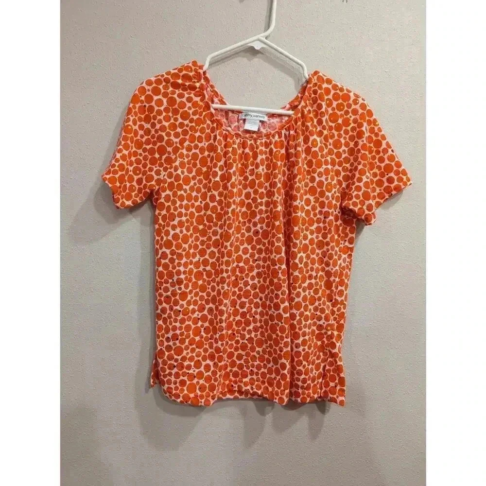 Short sleeve blouse w/orange circle & gold sequin detailing by Cathy Daniels, M